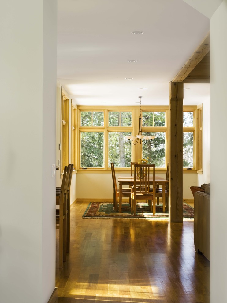 Design ideas for a large country hallway in Burlington with white walls and medium hardwood floors.