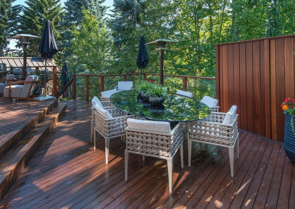 Large transitional backyard outdoor kitchen deck photo in Calgary with decking and no cover