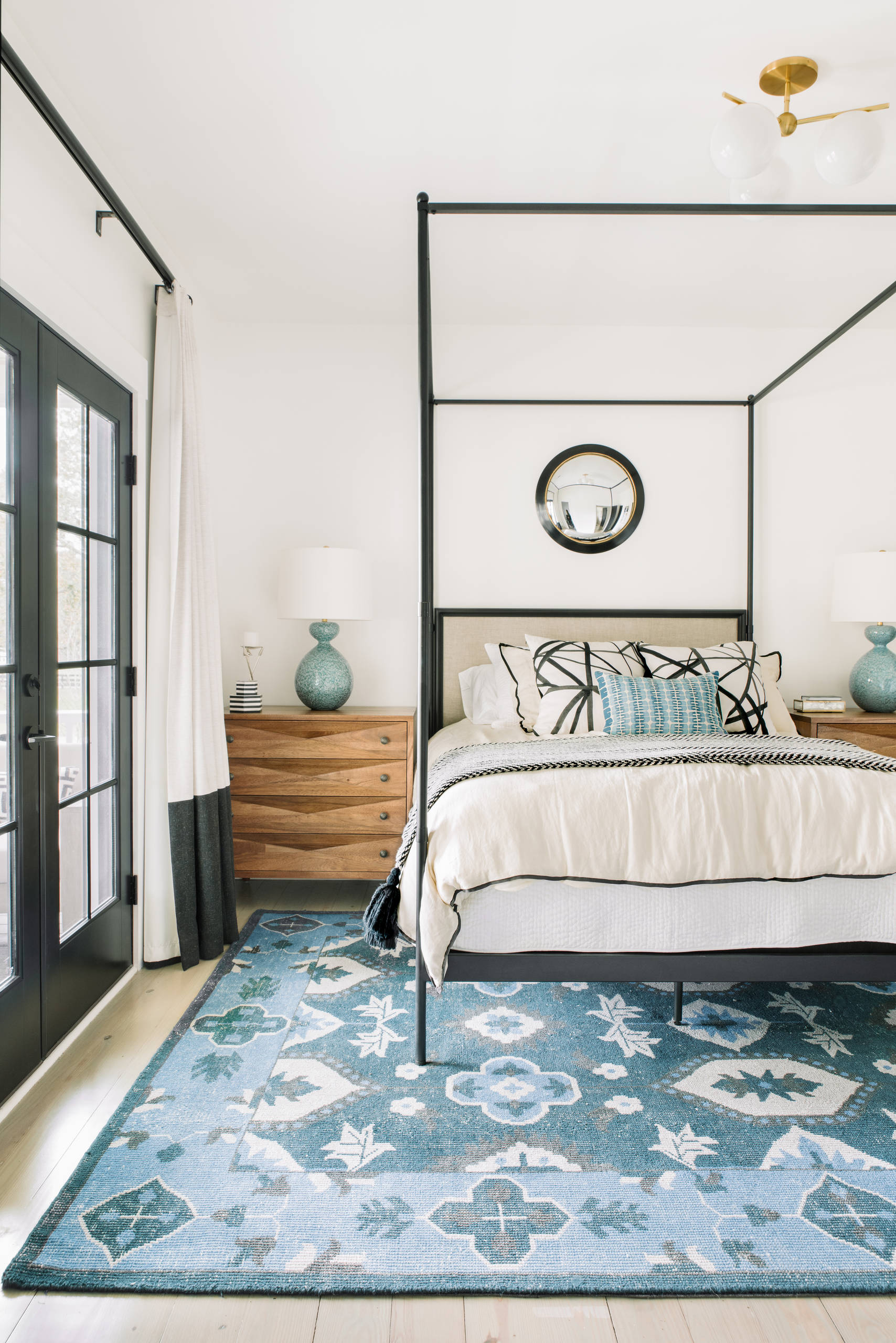Bright transitional bedroom with blue patterned rug