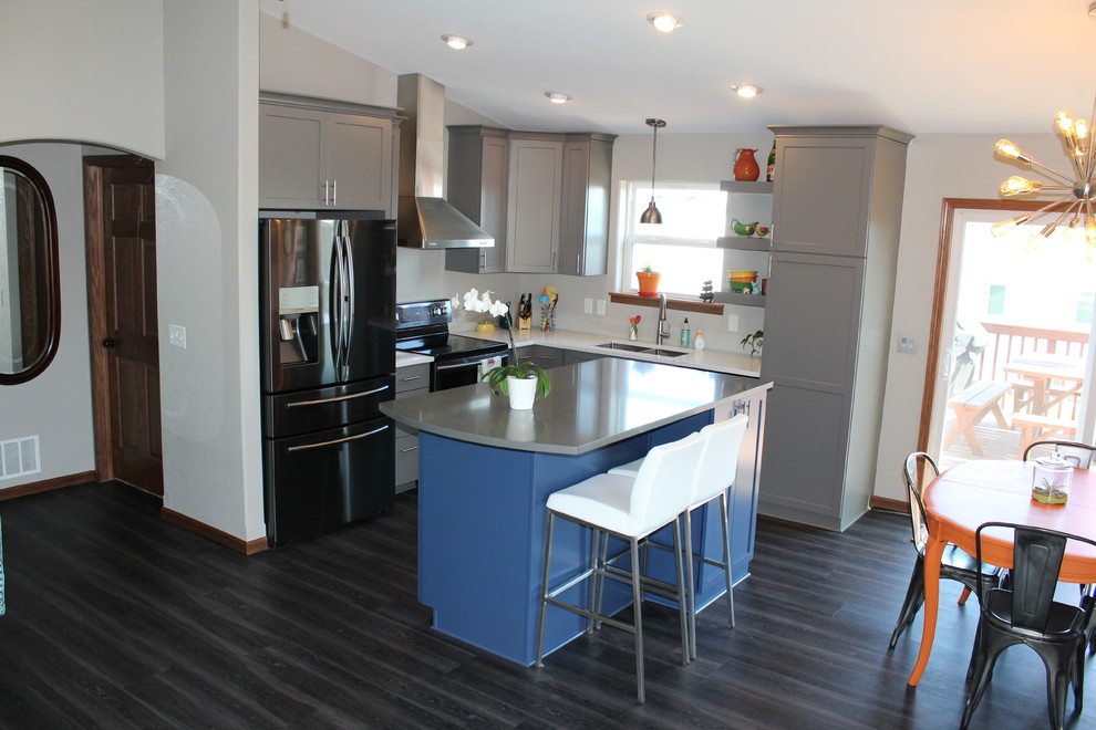 Inspiration for a mid-sized transitional l-shaped dark wood floor and black floor eat-in kitchen remodel with an undermount sink, shaker cabinets, gray cabinets, solid surface countertops, stainless steel appliances and an island