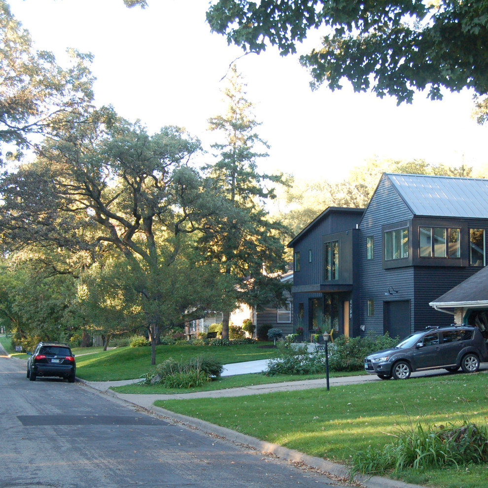 Inspiration for a modern exterior in Minneapolis with mixed siding.