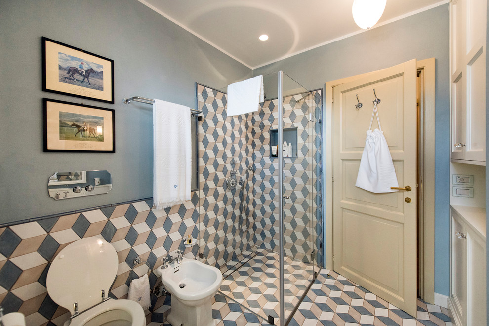 This is an example of a mid-sized country 3/4 bathroom in Other with a corner shower, multi-coloured tile, ceramic tile and a hinged shower door.