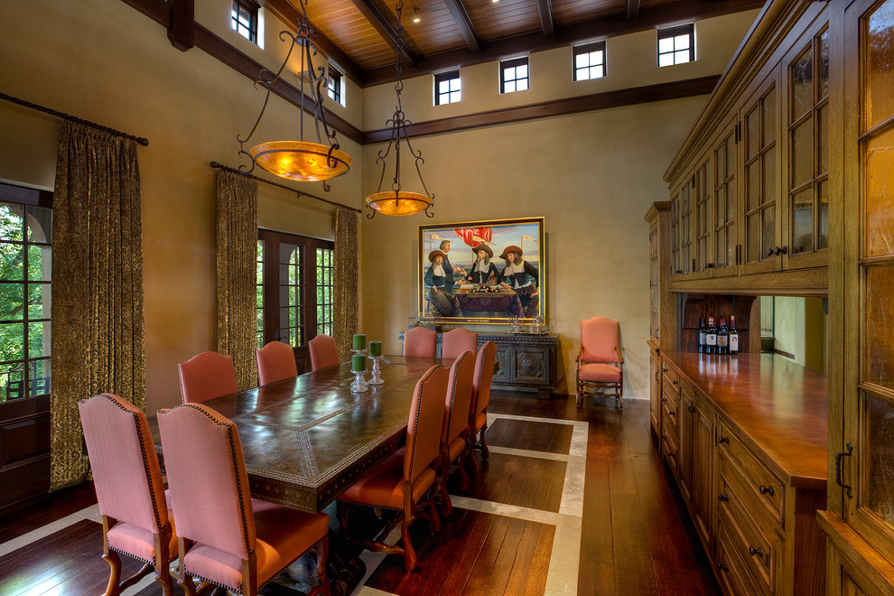 Photo of a mediterranean dining room in Cincinnati with beige walls and dark hardwood floors.