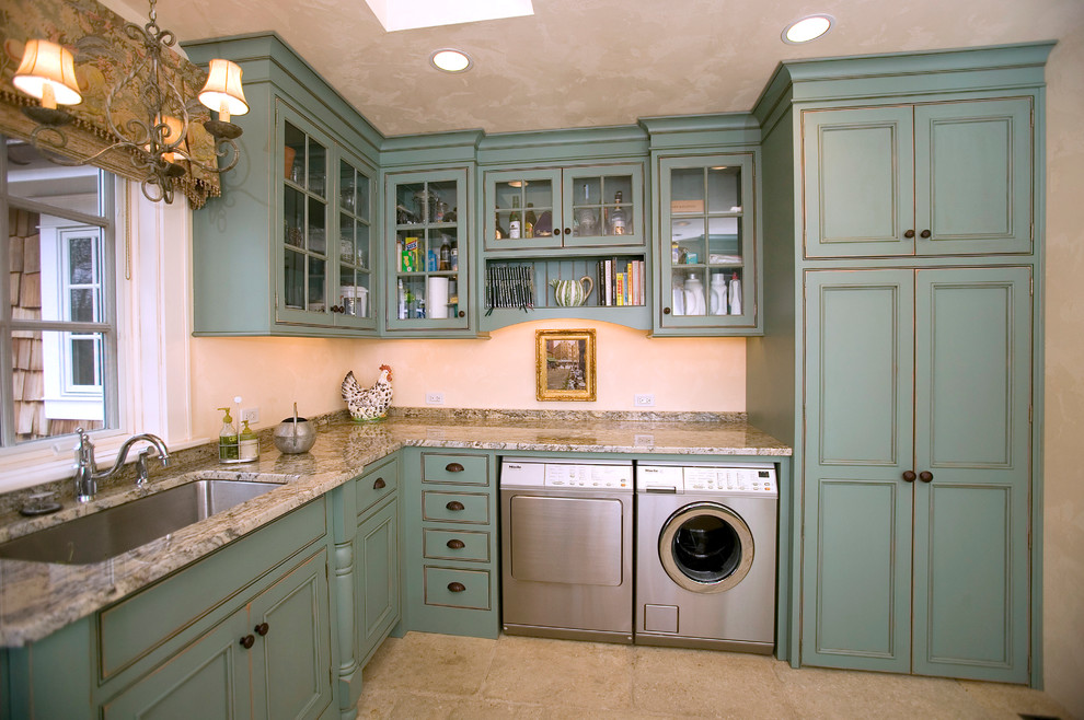 Photo of a mid-sized country l-shaped utility room in Cincinnati with an undermount sink, recessed-panel cabinets, blue cabinets, granite benchtops, a side-by-side washer and dryer, beige floor and beige benchtop.