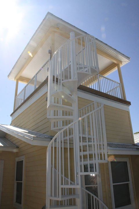This is an example of a large beach style metal spiral staircase in Orlando with open risers.