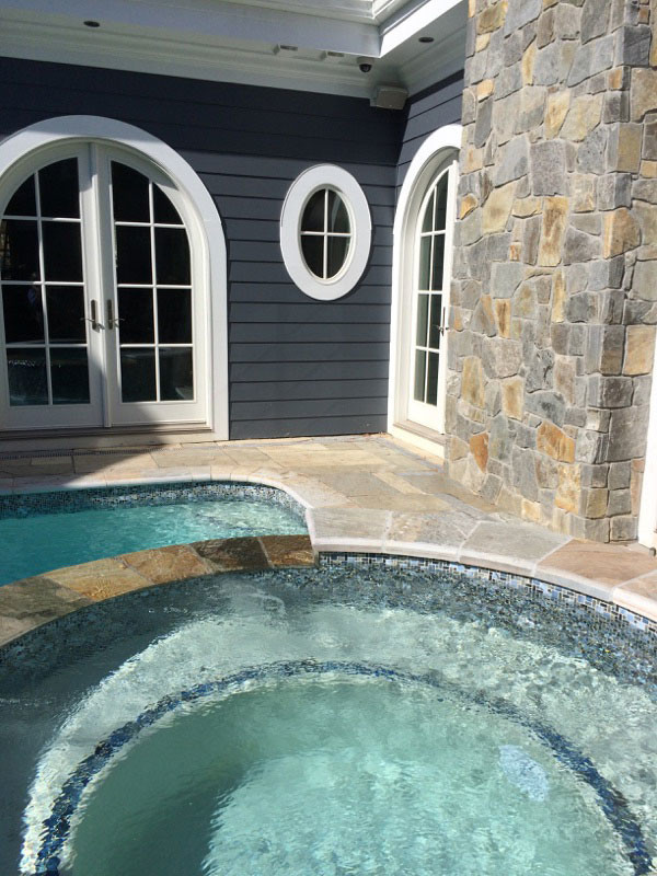 Small transitional backyard stone and rectangular lap hot tub photo