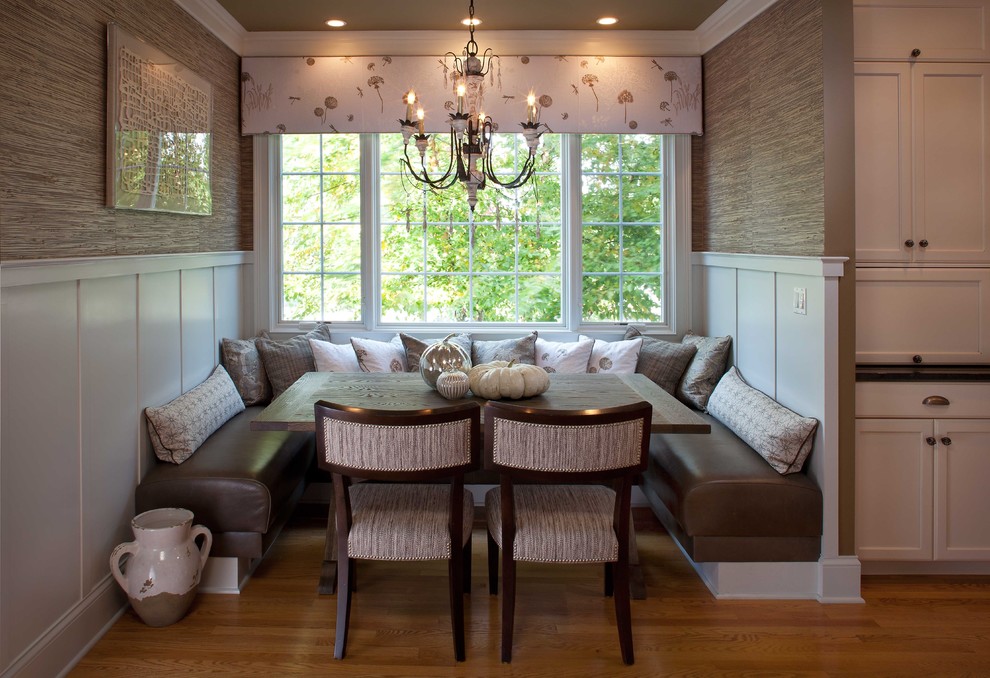 Example of a mid-sized transitional medium tone wood floor and brown floor great room design in Chicago with beige walls and no fireplace