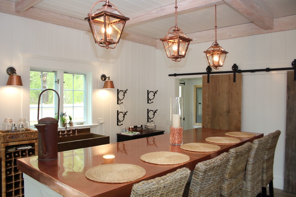 Inspiration for a mid-sized eclectic galley open plan kitchen in Boston with white cabinets, copper benchtops, with island and a farmhouse sink.