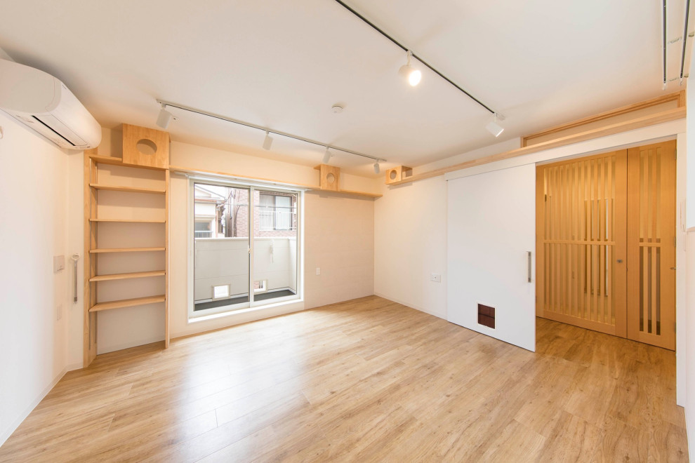 Design ideas for a mid-sized scandinavian gender-neutral kids' playroom in Tokyo with white walls, light hardwood floors, beige floor, wallpaper and brick walls.