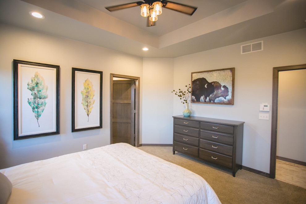 Mid-sized country guest bedroom in Other with white walls and carpet.