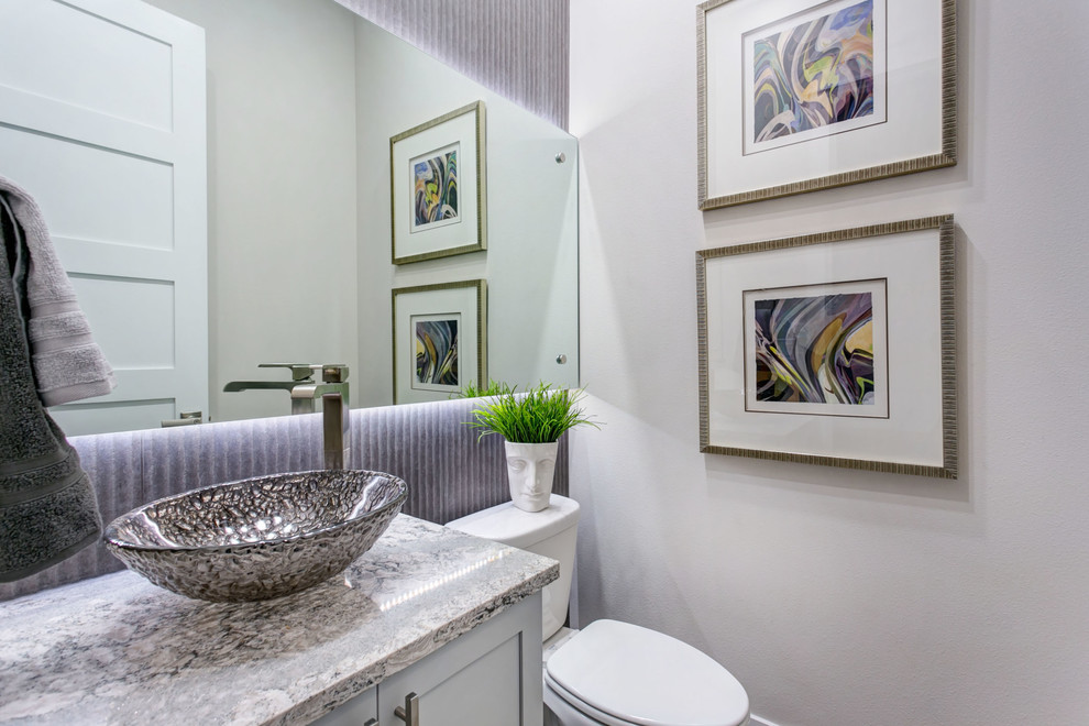 Design ideas for a small transitional bathroom in Seattle with shaker cabinets, white cabinets, a two-piece toilet, gray tile, porcelain tile, grey walls, light hardwood floors, a vessel sink, engineered quartz benchtops, grey floor and grey benchtops.