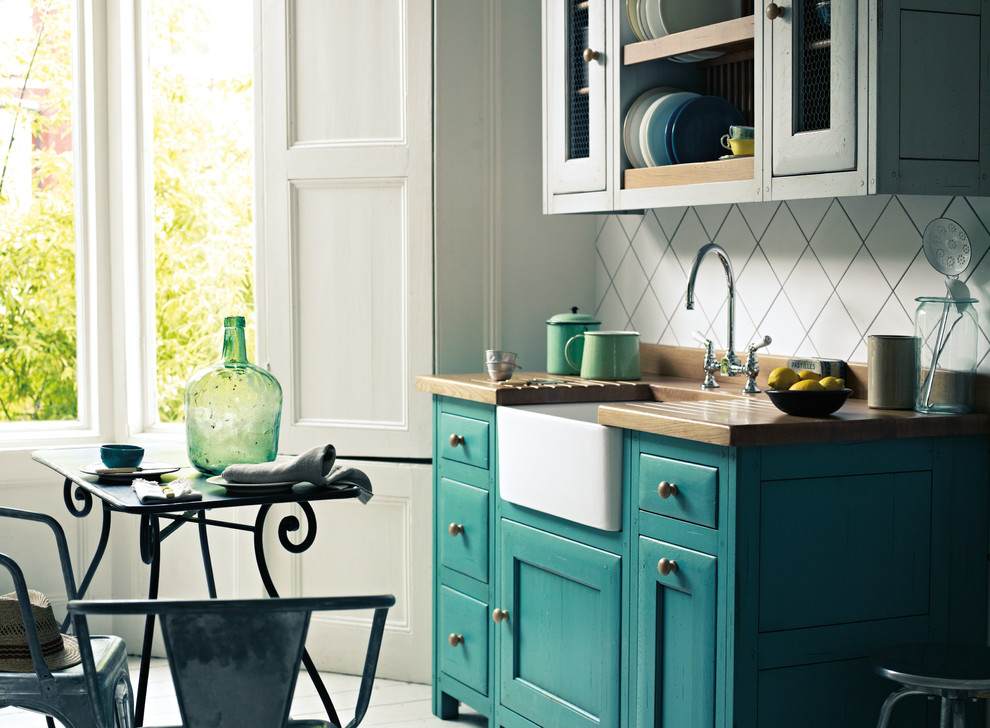 Inspiration for a country kitchen in Copenhagen with recessed-panel cabinets and green cabinets.