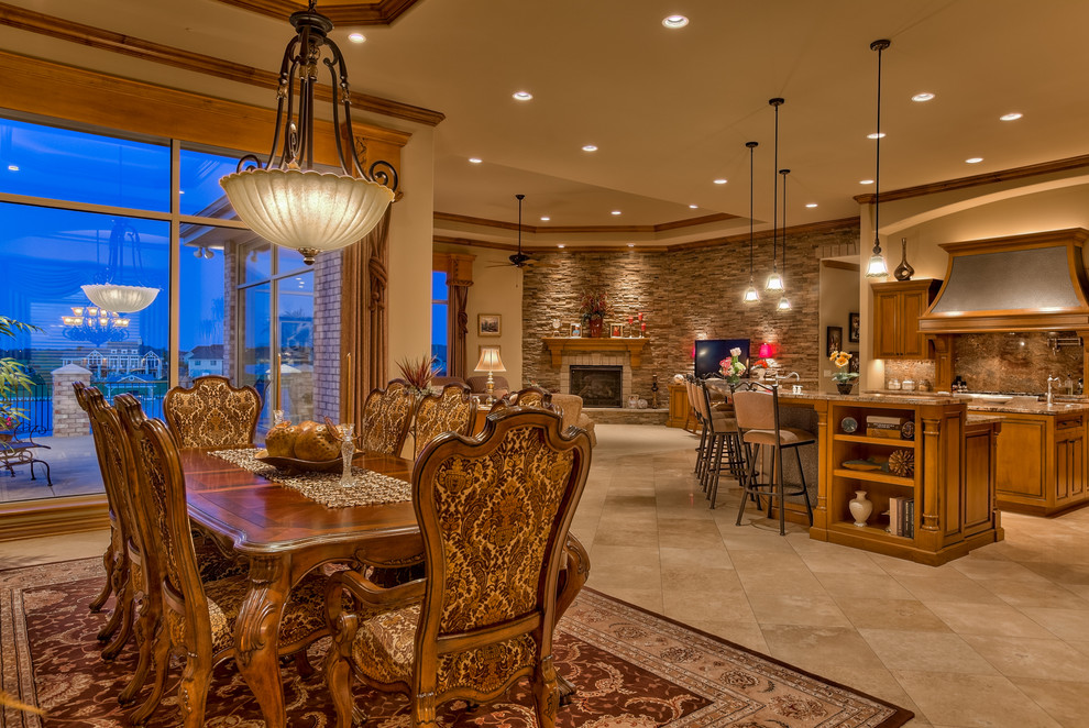 Inspiration for a large traditional kitchen/dining combo in Omaha with brown walls, porcelain floors, a corner fireplace and a stone fireplace surround.