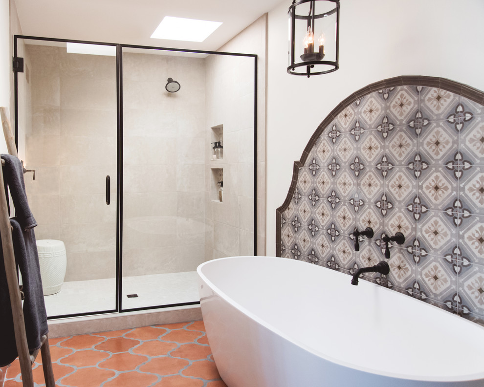 Photo of an expansive master bathroom in San Diego with raised-panel cabinets, medium wood cabinets, a freestanding tub, an alcove shower, multi-coloured tile, ceramic tile, white walls, terra-cotta floors, a vessel sink, orange floor, a hinged shower door and grey benchtops.