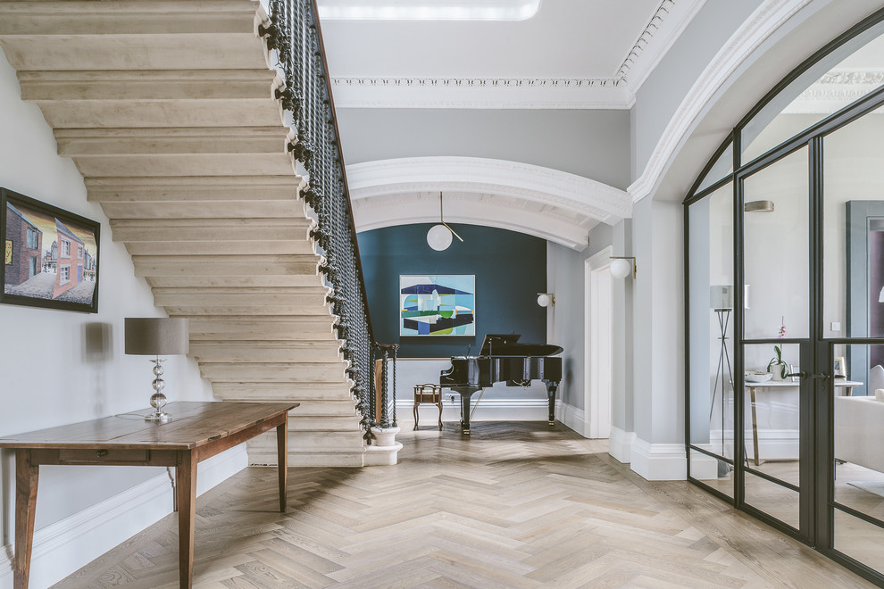 Design ideas for a large traditional hallway in Other with grey walls and light hardwood floors.