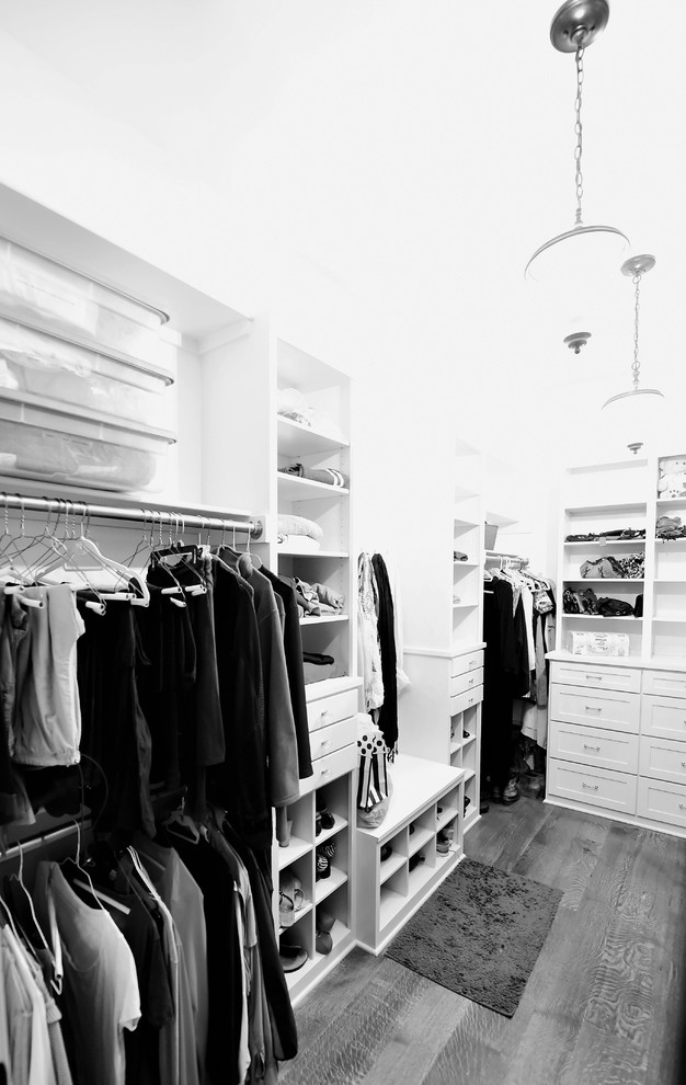 Walk-in closet - large rustic women's medium tone wood floor walk-in closet idea with shaker cabinets and white cabinets