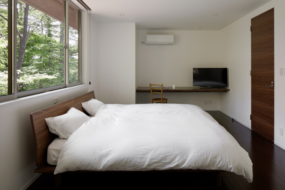 Inspiration for a modern master bedroom in Other with white walls, brown floor and plywood floors.