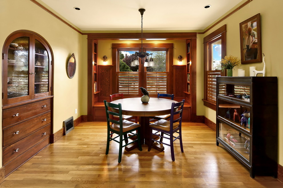 Design ideas for a mid-sized traditional separate dining room in Seattle with yellow walls, medium hardwood floors and no fireplace.
