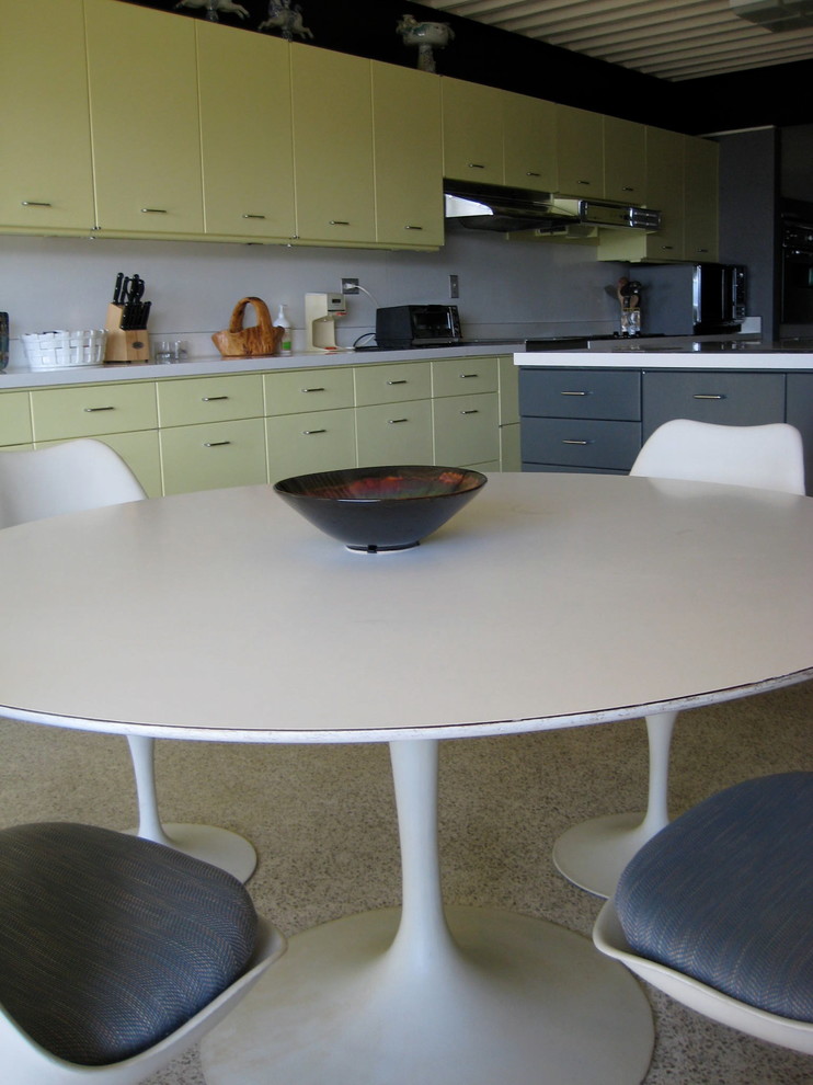 This is an example of a large modern kitchen in Other with a double-bowl sink, flat-panel cabinets, grey cabinets, laminate benchtops, stainless steel appliances, terrazzo floors and with island.