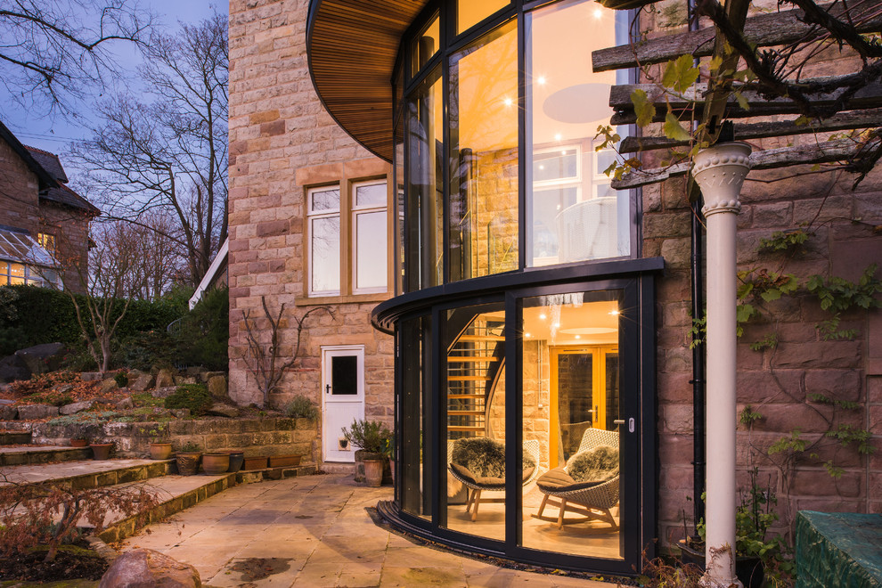 Photo of a large contemporary exterior in Other with stone veneer.