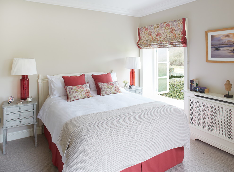 Design ideas for a mid-sized traditional guest bedroom in Dublin with white walls and carpet.