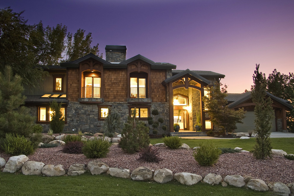 Mid-sized country two-storey brown house exterior in Salt Lake City with stone veneer, a gable roof and a shingle roof.