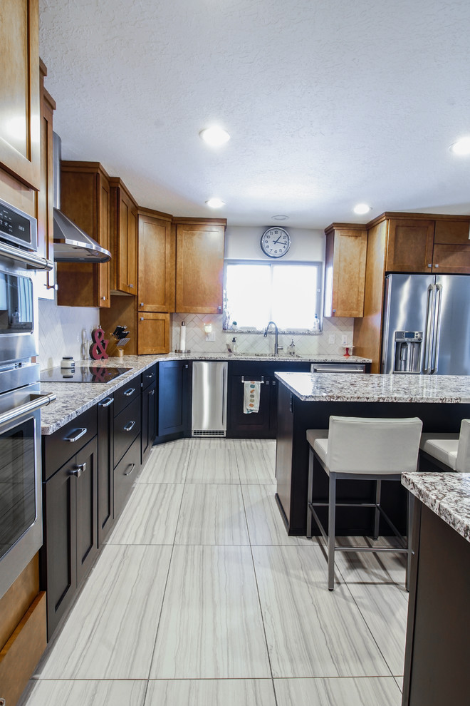 Eat-in kitchen - large transitional u-shaped porcelain tile and gray floor eat-in kitchen idea with shaker cabinets, dark wood cabinets, granite countertops, white backsplash, subway tile backsplash, stainless steel appliances and an island