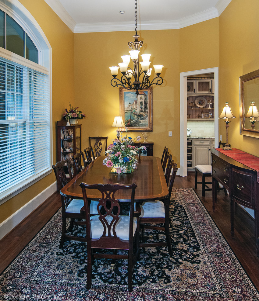 Design ideas for a large arts and crafts separate dining room in Other with yellow walls, dark hardwood floors and no fireplace.