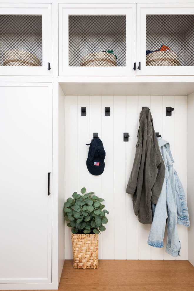Design ideas for a transitional mudroom in New York with white walls and planked wall panelling.
