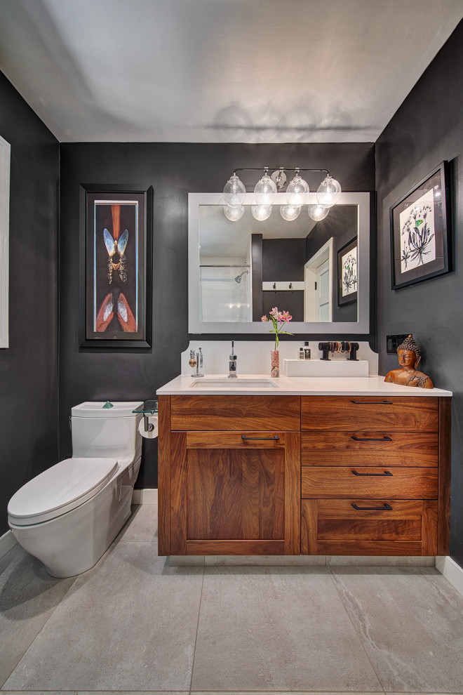 Design ideas for a mid-sized eclectic bathroom in Sacramento with shaker cabinets, medium wood cabinets, a one-piece toilet, black walls, porcelain floors, an undermount sink, engineered quartz benchtops, multi-coloured floor, white benchtops, a single vanity and a built-in vanity.