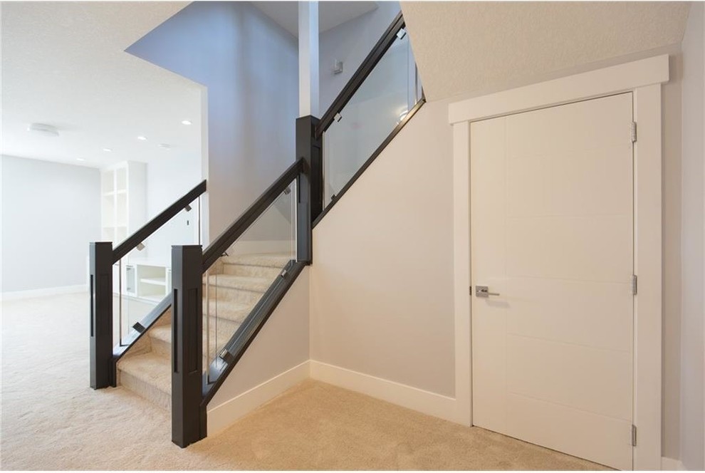 Staircase - mid-sized contemporary carpeted u-shaped staircase idea in Calgary with carpeted risers