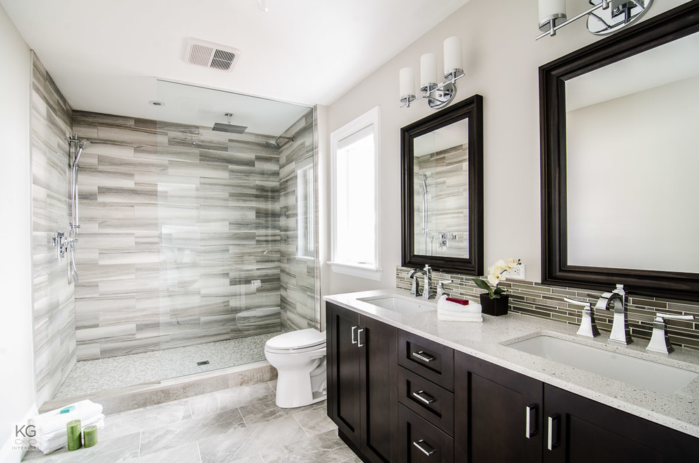 Inspiration for a transitional master bathroom in Toronto with an undermount sink, shaker cabinets, dark wood cabinets, engineered quartz benchtops, an open shower, porcelain tile, porcelain floors, brown walls and gray tile.