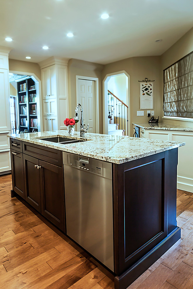 Elegant medium tone wood floor kitchen photo in Other with an undermount sink, shaker cabinets, mosaic tile backsplash and an island