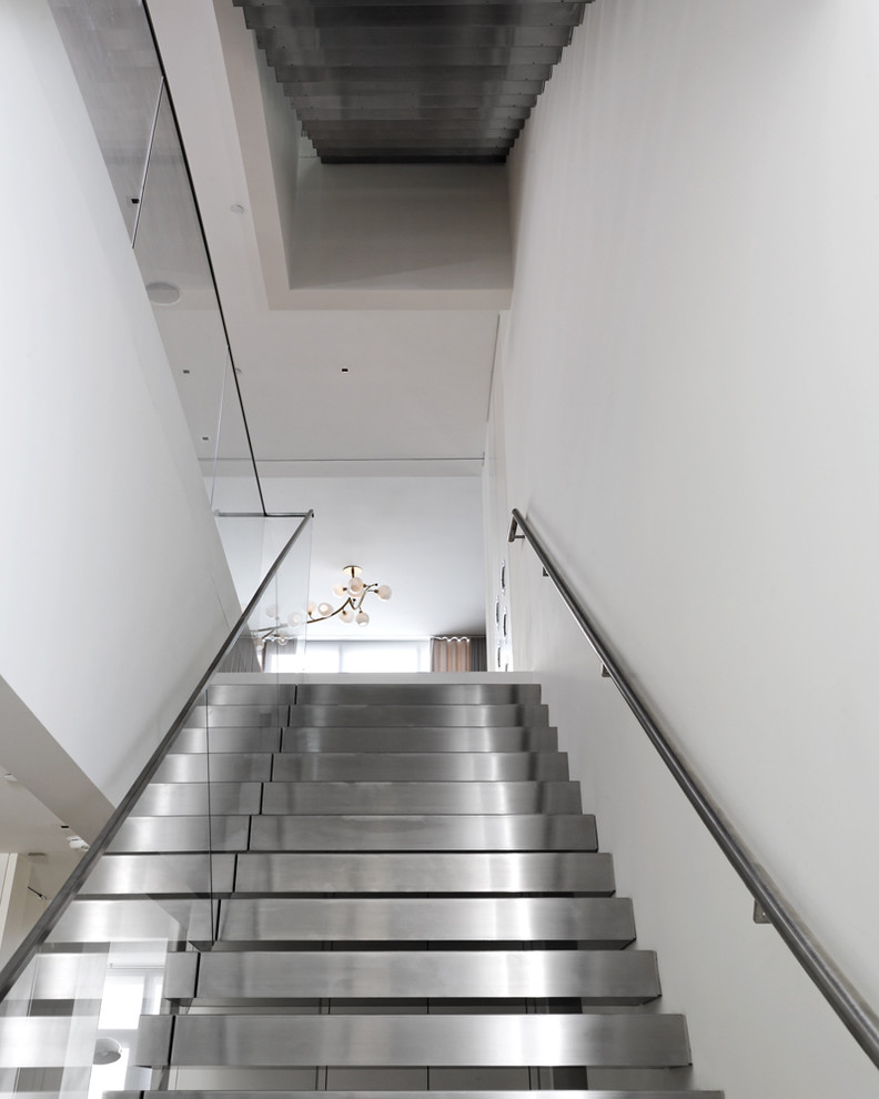 Photo of a contemporary metal floating staircase in New York with open risers.