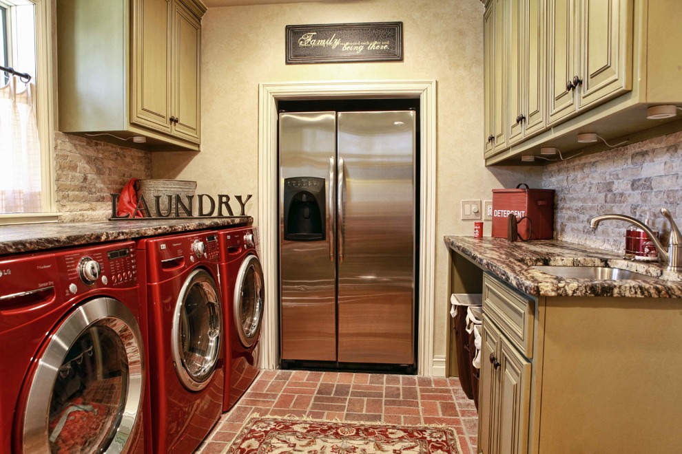 Photo of a traditional laundry room in Other with brick floors and red floor.