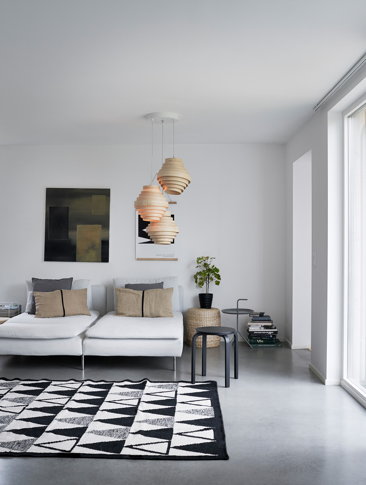 Scandinavian living room in Stockholm with white walls, concrete floors and grey floor.