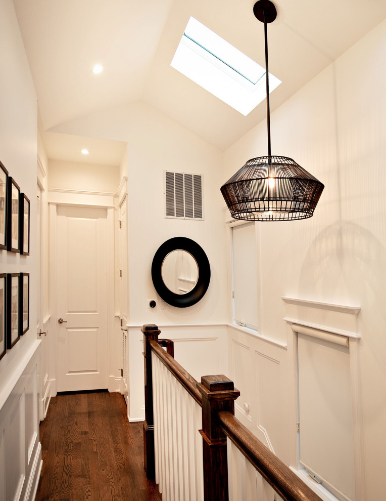 This is an example of a small contemporary hallway in Chicago with white walls, dark hardwood floors, white floor and vaulted.