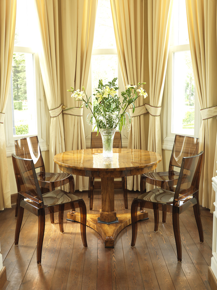 Inspiration for a contemporary dining room in London with dark hardwood floors.