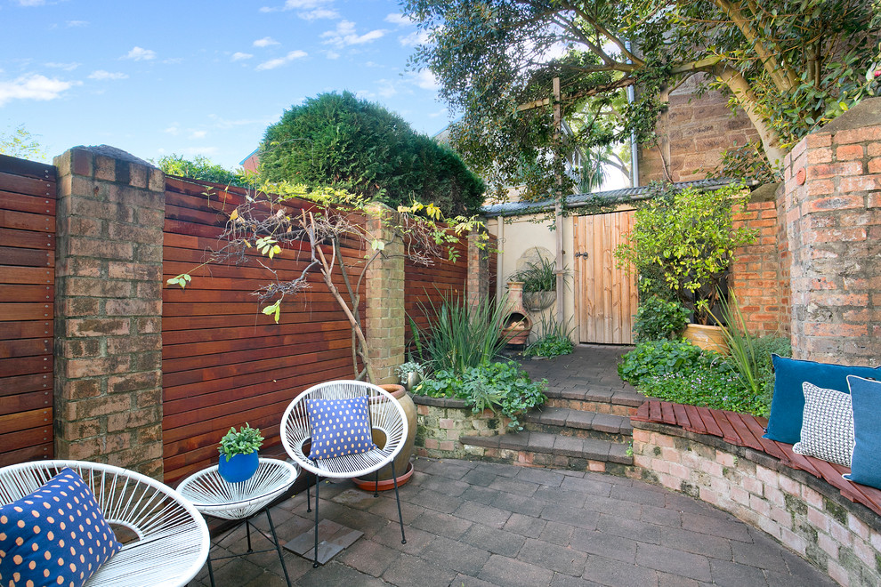 This is an example of a contemporary backyard patio in Sydney with brick pavers and no cover.
