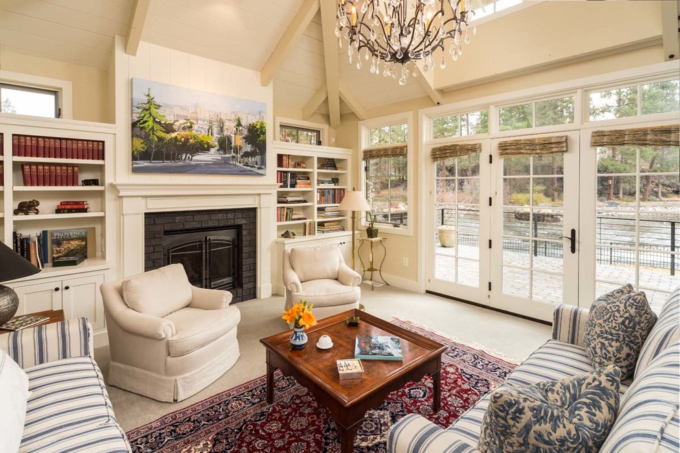 This is an example of a traditional living room in Other with a library, a standard fireplace and a brick fireplace surround.