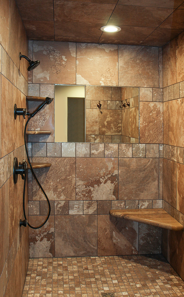 Mountain style master brown tile and ceramic tile ceramic tile doorless shower photo in Chicago with medium tone wood cabinets