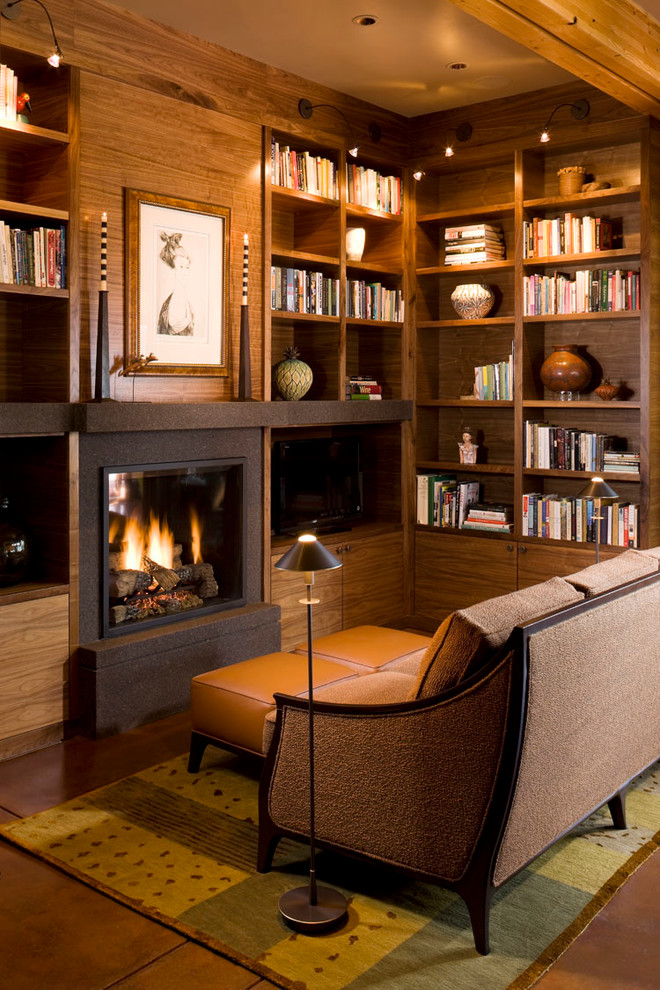 Photo of a country family room in Denver with a library, a standard fireplace and a freestanding tv.