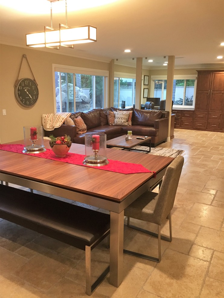 This is an example of a large traditional open plan dining in Orange County with beige walls, travertine floors and beige floor.
