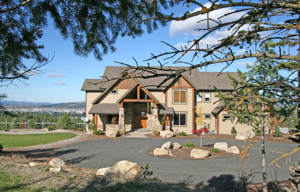 Example of a large mountain style brown two-story mixed siding gable roof design in Seattle