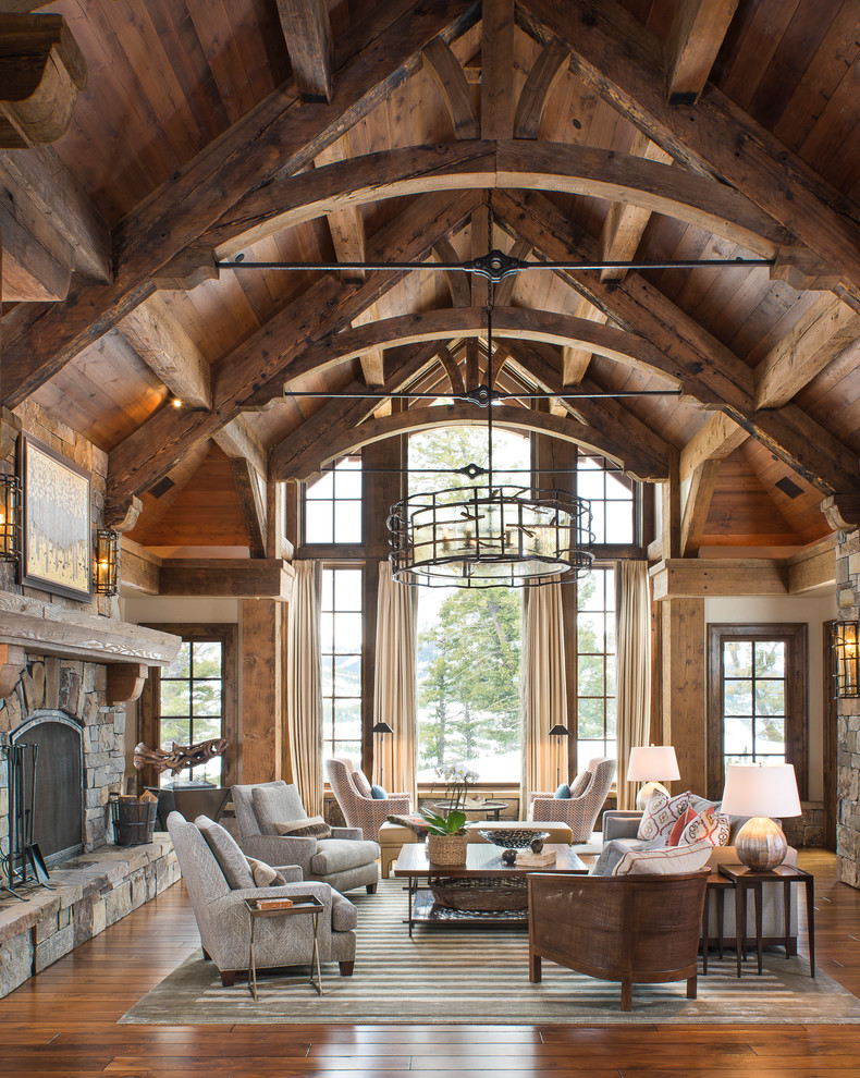 Inspiration for a country formal living room in Other with medium hardwood floors, a standard fireplace, a stone fireplace surround and orange floor.