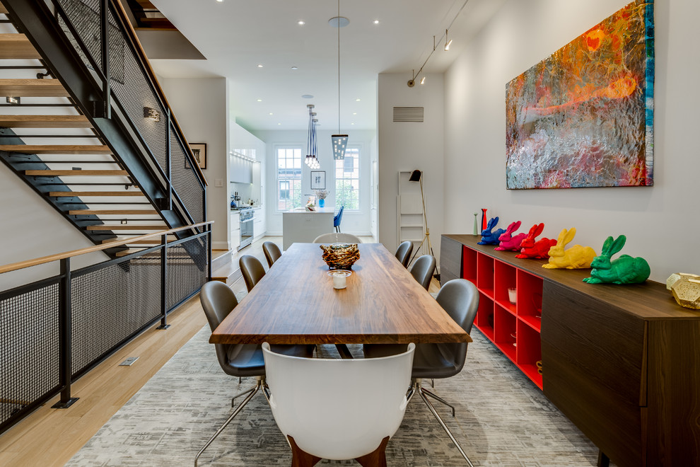 Contemporary open plan dining in Baltimore with grey walls and light hardwood floors.