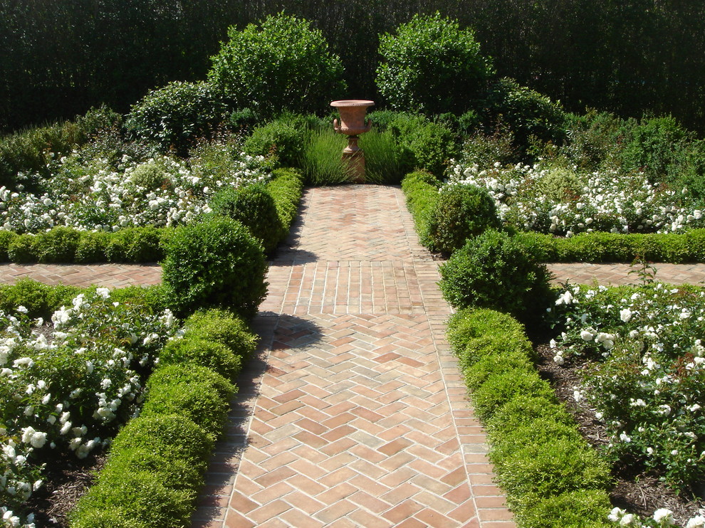 Design ideas for a victorian back formal garden in Other with brick paving.