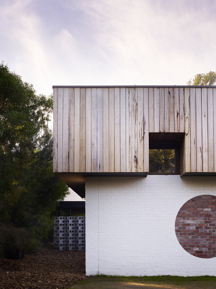 This is an example of a contemporary two-storey brown exterior in Melbourne with a flat roof.