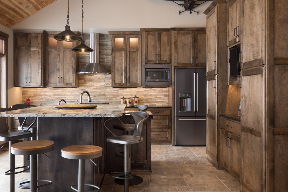 Inspiration for a rustic l-shaped gray floor kitchen remodel with shaker cabinets, dark wood cabinets, beige backsplash, stainless steel appliances, an island and gray countertops