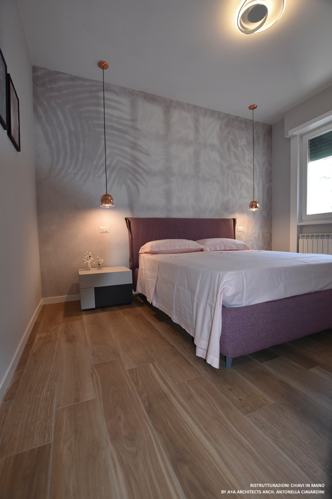 Inspiration for a large modern master bedroom in Other with multi-coloured walls, porcelain floors and wallpaper.